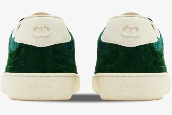 Rear view of Gucci G74 sneakers in green suede with interlocking G logo on white heel tabs and off-white soles. - SKU 791742AADM03143