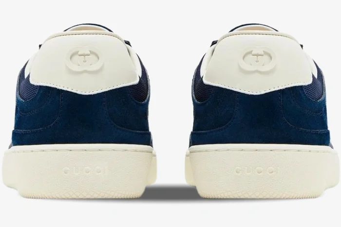 Rear view of Gucci G74 sneakers in blue suede with white interlocking G heel tabs and cream soles. - SKU 791742AADM04141