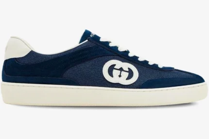 Side profile of a Gucci G74 Interlocking G blue suede sneaker with white sole and laces. - SKU 791742AADM04141