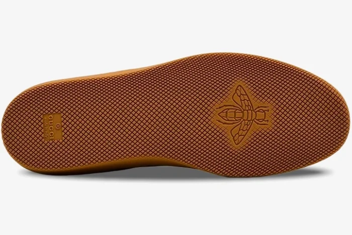 Bottom view of the Gucci G75 gum rubber sole featuring a textured pattern and embossed bee logo. - SKU 791742AAEGA2242