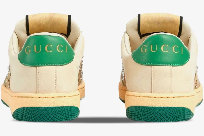 Rear view of ivory Gucci Screener Low Top GG Crystal Canvas sneakers with green heel tabs and gold logo. - SKU 812041AAEB29541