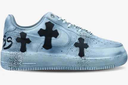 Side profile of a custom Nike Air Force 1 in metallic silver with black Chrome Hearts cross patches.