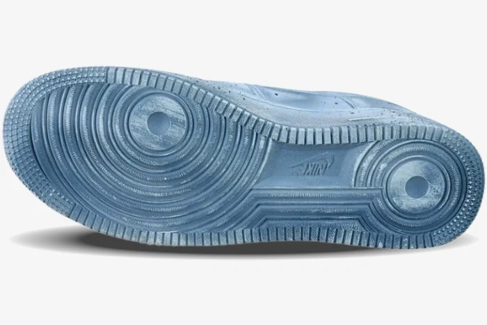 Bottom view of a light blue custom Air Force 1 Chrome Hearts sneaker outsole with circular traction pattern.
