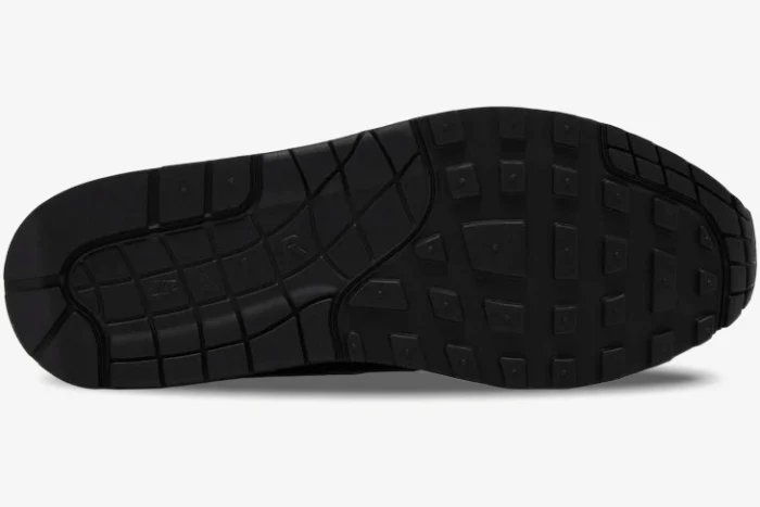 Bottom view of the black rubber outsole on a Nike Air Max 1 '87 SP x Supreme sneaker. - SKU HF8813-001