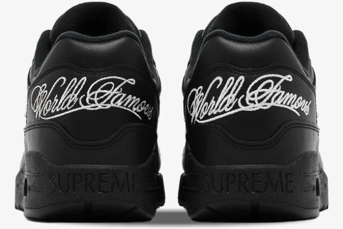 Rear view of black Nike Air Max 1 '87 SP x Supreme sneakers with white 'World Famous' embroidery. - SKU HF8813-001