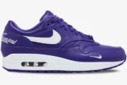 Side view of the Nike Air Max 1 x Supreme Purple White sneaker featuring leather upper and visible air unit. - SKU HF8813-500