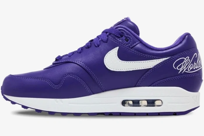Side profile of a Nike Air Max 1 x Supreme sneaker in purple leather with a white swoosh and midsole. - SKU HF8813-500