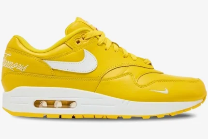 Nike Air Max 1 x Supreme limited edition yellow leather sneaker, side profile view with white Swoosh and midsole. - SKU HF8813-700