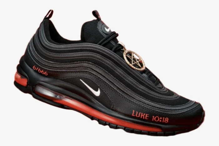 Side profile of a black Nike Air Max 97 Satan Shoe custom with red liquid soles and a pentagram charm.