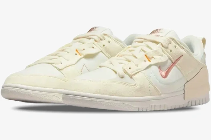 Nike Dunk Low Disrupt 2 Pale Ivory and Sail sneakers shown from a three-quarter front perspective. - SKU DH4402-101