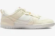 Side profile of Nike Dunk Low Disrupt 2 sneakers in pale ivory and sail on a white background. - SKU DH4402-101