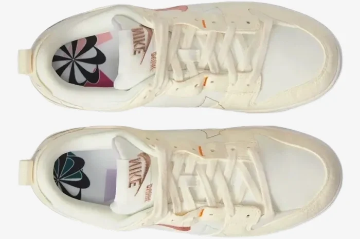 Top-down view of Nike Dunk Low Disrupt 2 sneakers in Pale Ivory and Sail with graphic insoles. - SKU DH4402-101