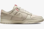 Nike Dunk Low SE Sashiko Light Orewood Brown sneaker in a side profile view with red stitching details. - SKU DV0834-100
