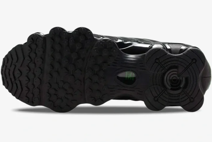 Bottom view of the Nike Shox TL Black Green Strike outsole showing the black rubber tread pattern. - SKU AV3595-012