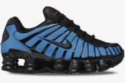 Nike Shox TL Thermoactive sneaker in black and blue, side profile view showing the iconic Shox pillars.