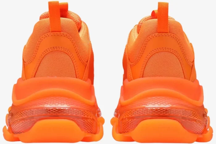 Back view of Balenciaga Triple S sneakers in vibrant clear sole orange.