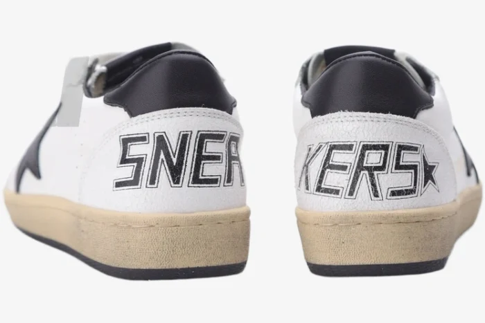 Rear view of Golden Goose Ball Star Sport Sneakers in white and black with SNEAKERS text on heels. - SKU GMF00117.F002554.10100