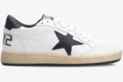 Side profile of a Golden Goose Ball Star sneaker in white and black with a distressed cream sole. - SKU GMF00117.F002554.10100