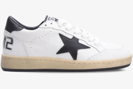 Side profile of a Golden Goose Ball Star sneaker in white and black with a distressed cream sole. - SKU GMF00117.F002554.10100