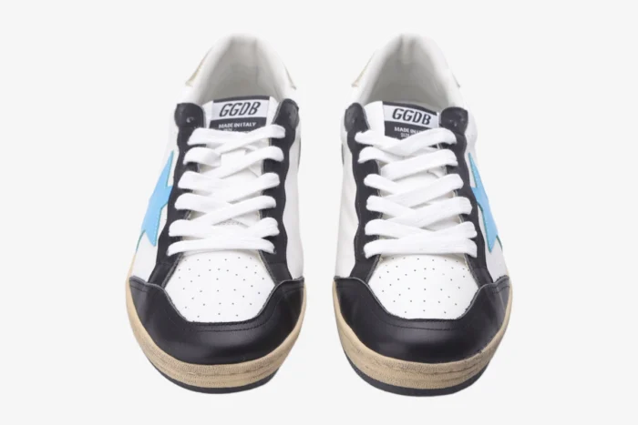 Front view of Golden Goose Ball Star white leather sneakers with blue stars and black accents. - SKU GMF00117.F002573.10915