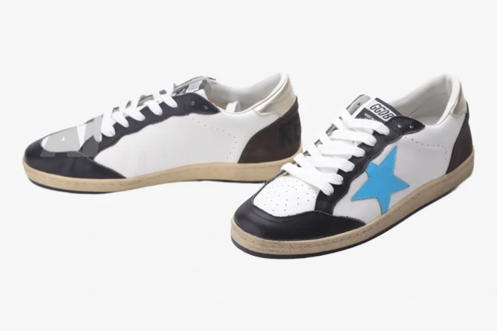 Golden Goose Ball Star white leather sneakers with blue star and brown heel, angled front view. - SKU GMF00117.F002573.10915