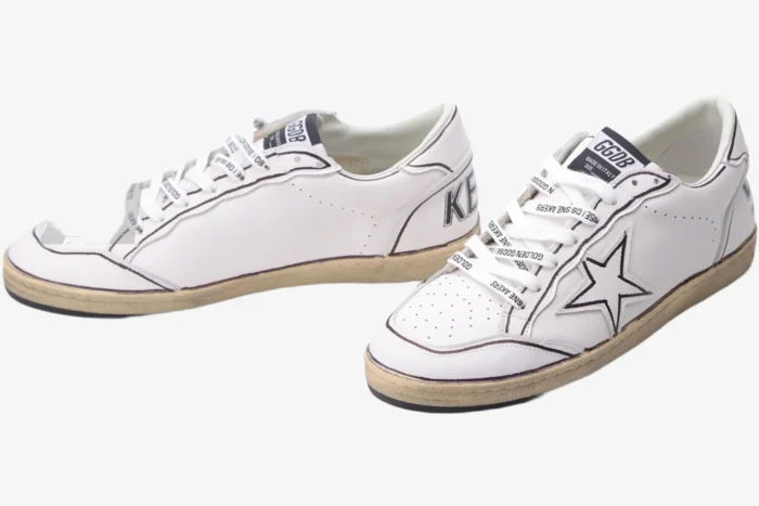 Golden Goose Ball Star white sneakers with brown outlines and star detail, three-quarter view. - SKU GMF00117.F002575.10915