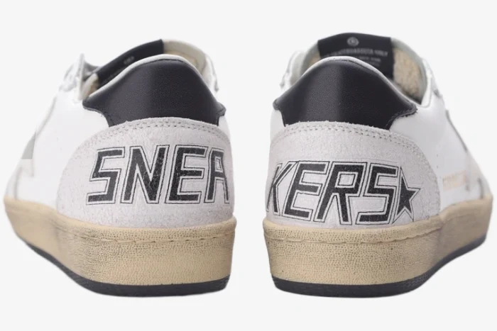 Rear view of Golden Goose Ball Star white grey black distressed leather sneakers with 'SNEAKERS' text on heels.