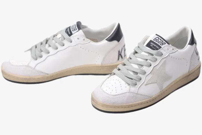 Golden Goose Ball Star white and grey distressed leather sneakers with black heel tab, three-quarter view.