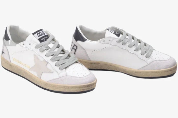Three-quarter view of Golden Goose Ball Star white grey black distressed leather sneakers on a white background.