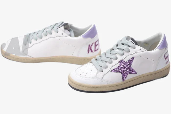 Golden Goose Ball Star white sneakers with a purple glitter star and lavender heel, three-quarter view. - SKU GWF00117.F002544.10915