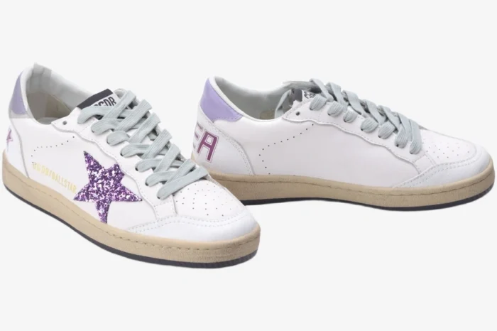 Golden Goose Ball Star sneakers in white leather with a purple glitter star and grey laces, three-quarter view. - SKU GWF00117.F002544.10915