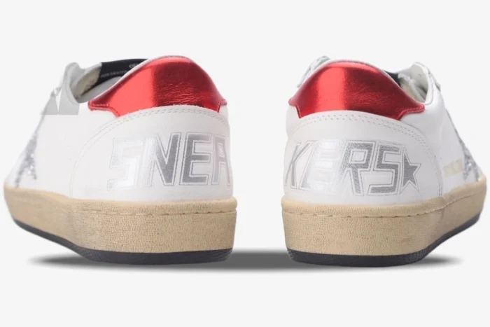 Rear view of Golden Goose Ball Star white sneakers with red metallic heel tabs and silver SNEAKERS text. - SKU GWF00117.F002517.10892