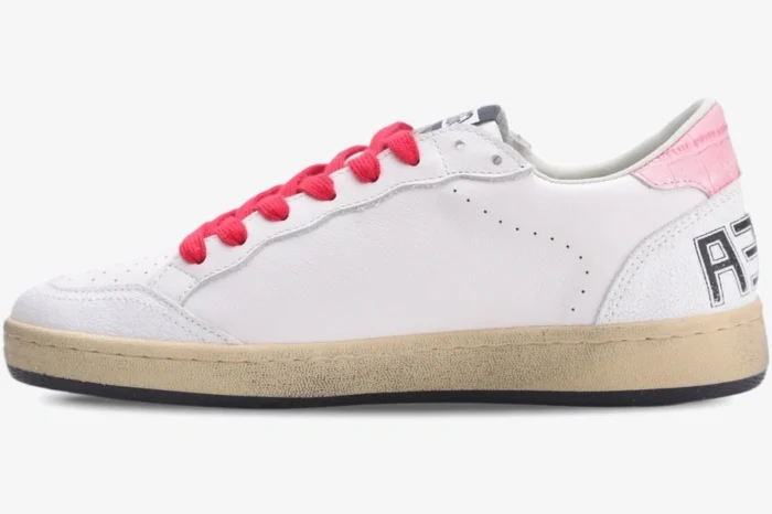 Side view of Golden Goose Ball Star white leather sneaker with red laces and pink glitter heel tab. - SKU GWF00117.F002517.10893