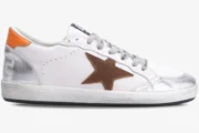 Side view of a white Golden Goose Ball Star sneaker with silver metallic toe and heel, brown star, and orange tab. - SKU GMF00117.F002585.10912