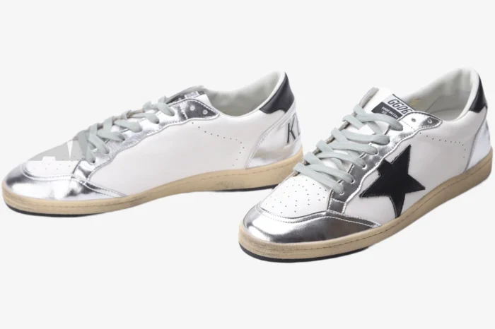 Pair of Golden Goose Ball Star white and silver distressed sneakers with black star logo, three-quarter view. - SKU GWF00117.F002517.10272