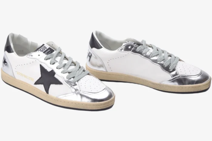 Three-quarter view of Golden Goose Ball Star white and silver distressed sneakers with a black star logo. - SKU GWF00117.F002517.10272