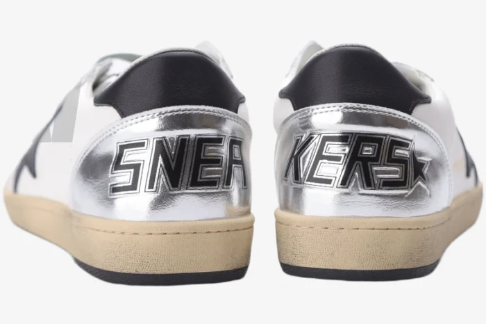Rear view of Golden Goose Ball Star white and silver distressed sneakers with 'SNEAKERS' text on heels. - SKU GWF00117.F002517.10272
