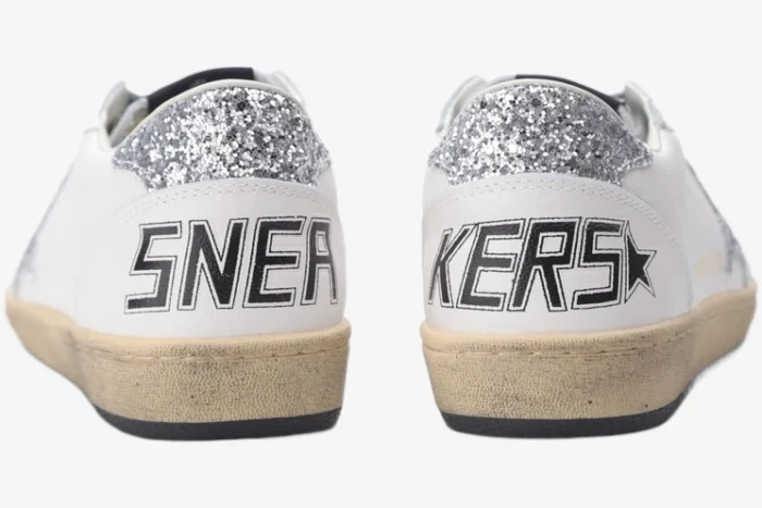 Rear view of Golden Goose Ball Star white and silver glitter sneakers with 'SNEAKERS' text on the heels. - SKU GWF00117.F002564.10273