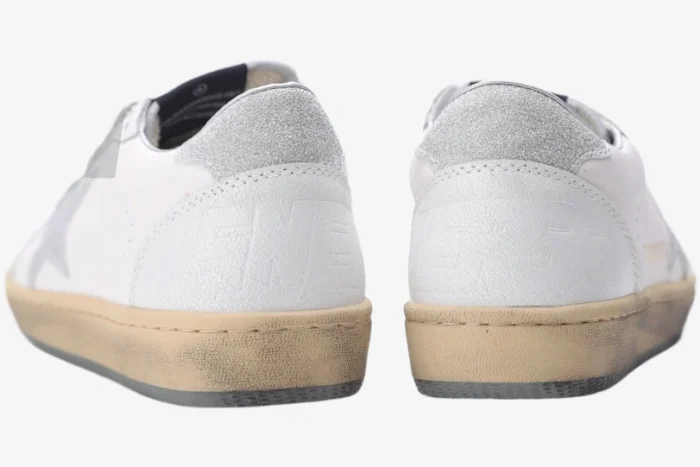 Rear view of Golden Goose Ball Star white leather sneakers featuring silver glitter heel tabs. - SKU GWF00117.F002573.10915