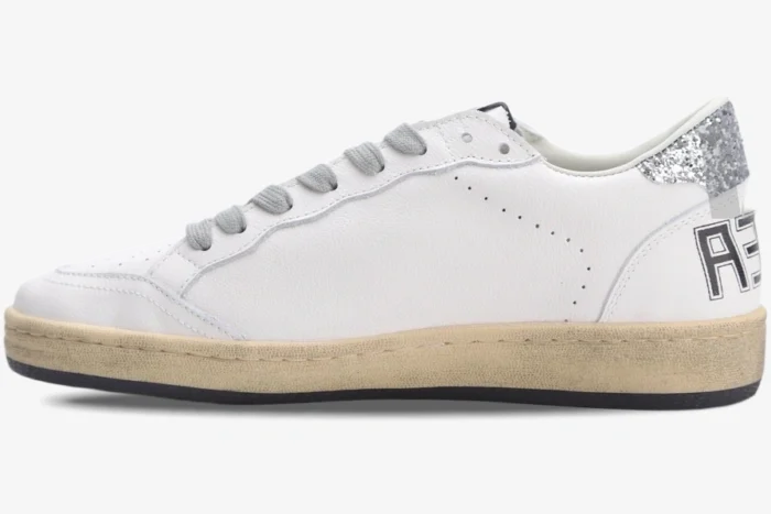 Side profile of Golden Goose Ball Star white leather sneakers with silver glitter heel and aged sole. - SKU GWF00117.F002564.10273