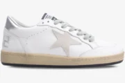Side view of a Golden Goose Ball Star white leather sneaker with a silver heel and beige distressed sole. - SKU GWF00117.F002570.10925