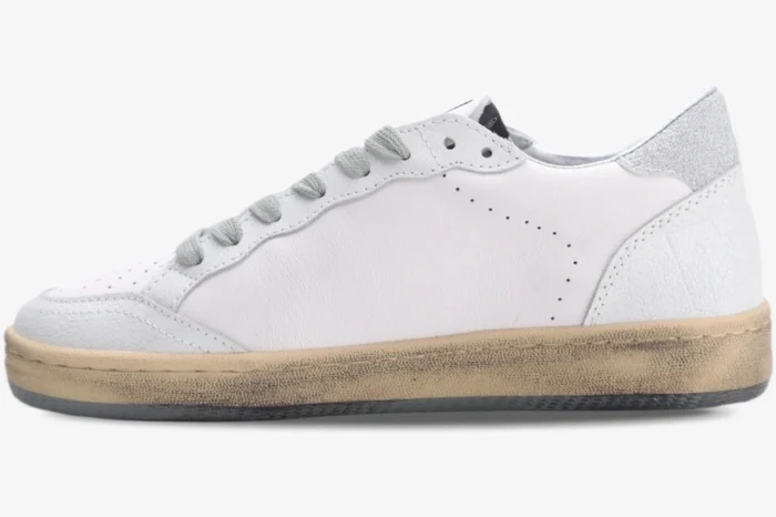 Side profile of Golden Goose Ball Star sneakers in white leather with silver glitter heel and distressed sole. - SKU GWF00117.F002573.10915