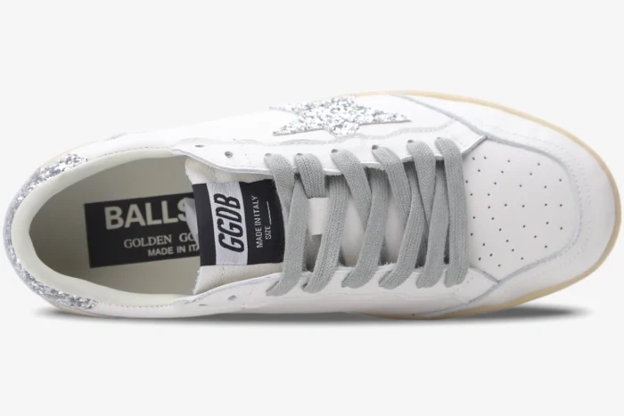 Top-down view of Golden Goose Ball Star white leather sneakers with silver glitter star and grey laces. - SKU GWF00117.F002564.10273