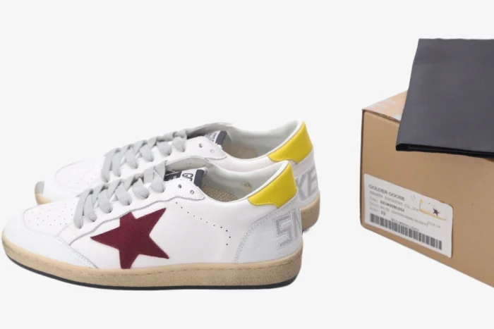 Golden Goose Ball Star sneakers in white distressed leather with a red star and yellow heel tab, side view with box. - SKU GMF00117.F002558.10915