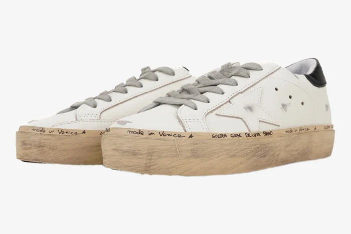 Three-quarter view of Golden Goose white and black Hi Star platform sneakers with distressed soles. - SKU GWF00118.F000329.10271