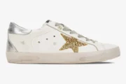 Golden Goose Super-Star sneaker in white with a gold glitter star and silver heel tab, side view. - SKU GWF00101.F000312.10272