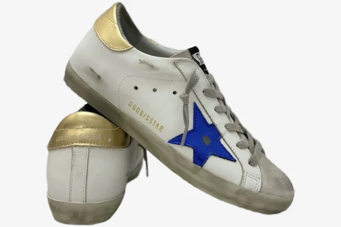 Golden Goose Super-Star sneakers in distressed white leather with gold heel and navy star, side view. - SKU GMF00101.F000312.10272