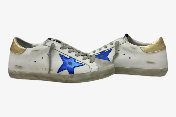 Golden Goose Super-Star sneakers in distressed white leather with blue star and gold heel, side view. - SKU GMF00101.F000312.10272