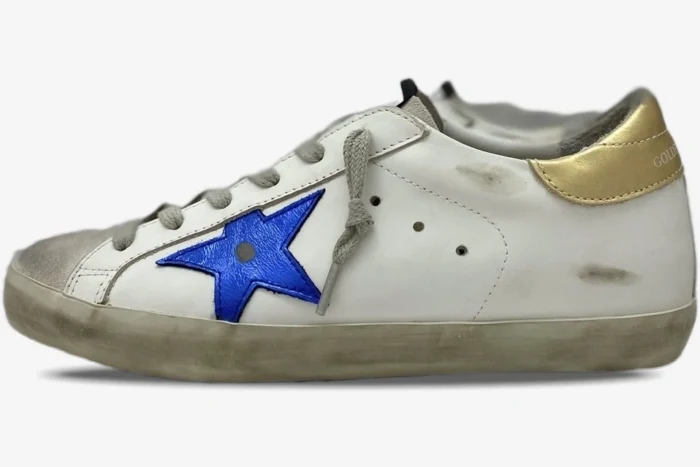 Golden Goose Super-Star sneaker in white leather with a blue star and gold heel, side profile view. - SKU GMF00101.F000312.10272