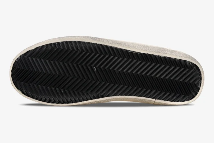 Bottom view of Golden Goose Super-Star sneaker showing black herringbone rubber outsole and white midsole. - SKU GMF00101.F000312.10273